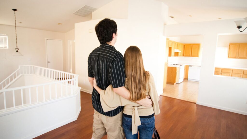 a couple embracing in their new home