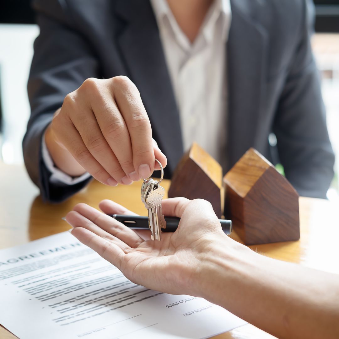 Real estate agent handing over the keys to a client