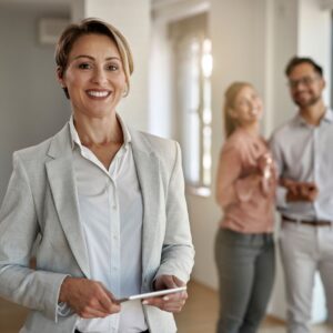 real estate agent and couple buying a house