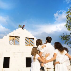 people looking at a house being built