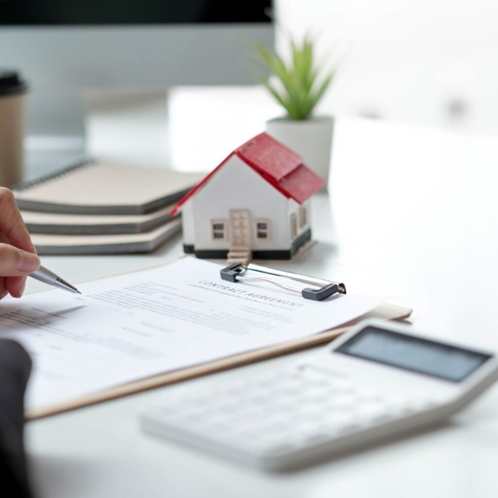 investors looking at paperwork with calculator