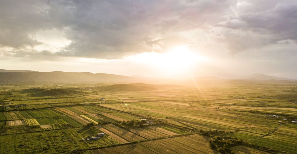 sun shining over areal view of land