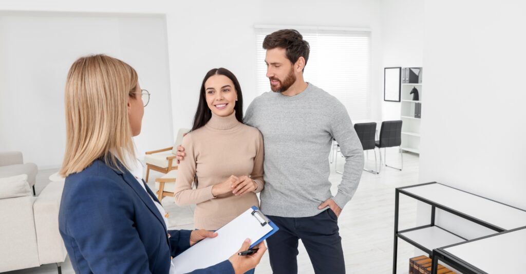 image of a couple meeting with a real estate agent