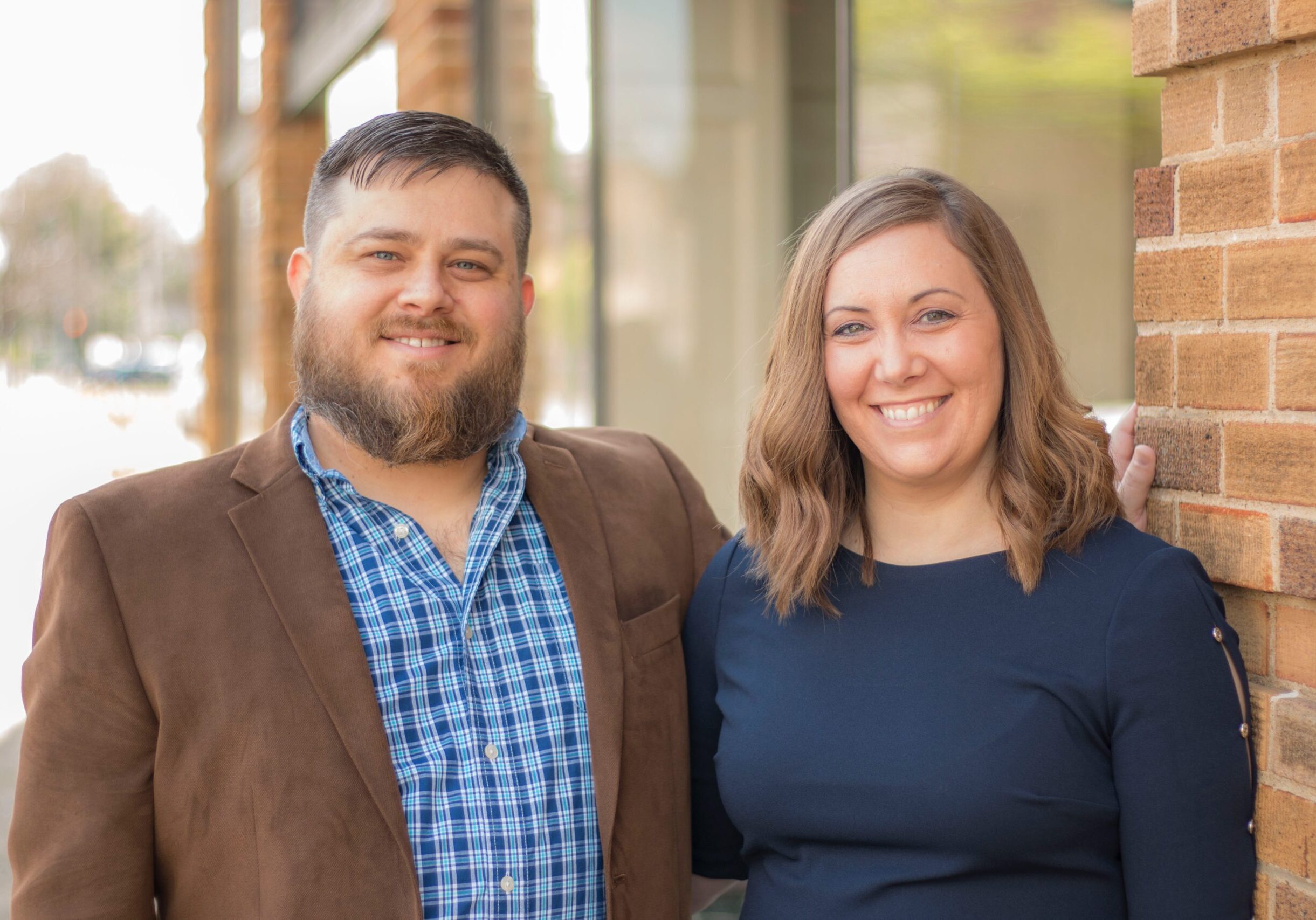 image of happy couple in front of their new home.